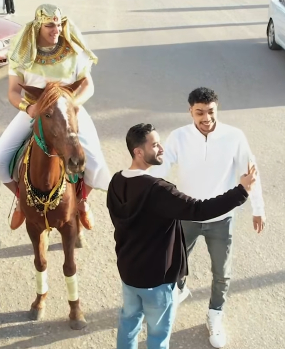 التقاط الصور التذكارية مع شاب يرتدي الزي الفرعوني في شوارع رأس البر